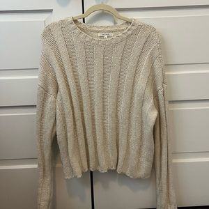 Packing knit sweater in cream